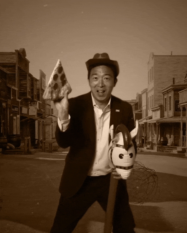 Andrew Yang acting out a western scene with a piece of pizza in hand