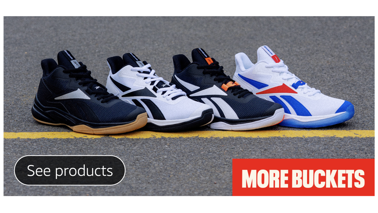 Four pairs of reebok shoes sitting on the street