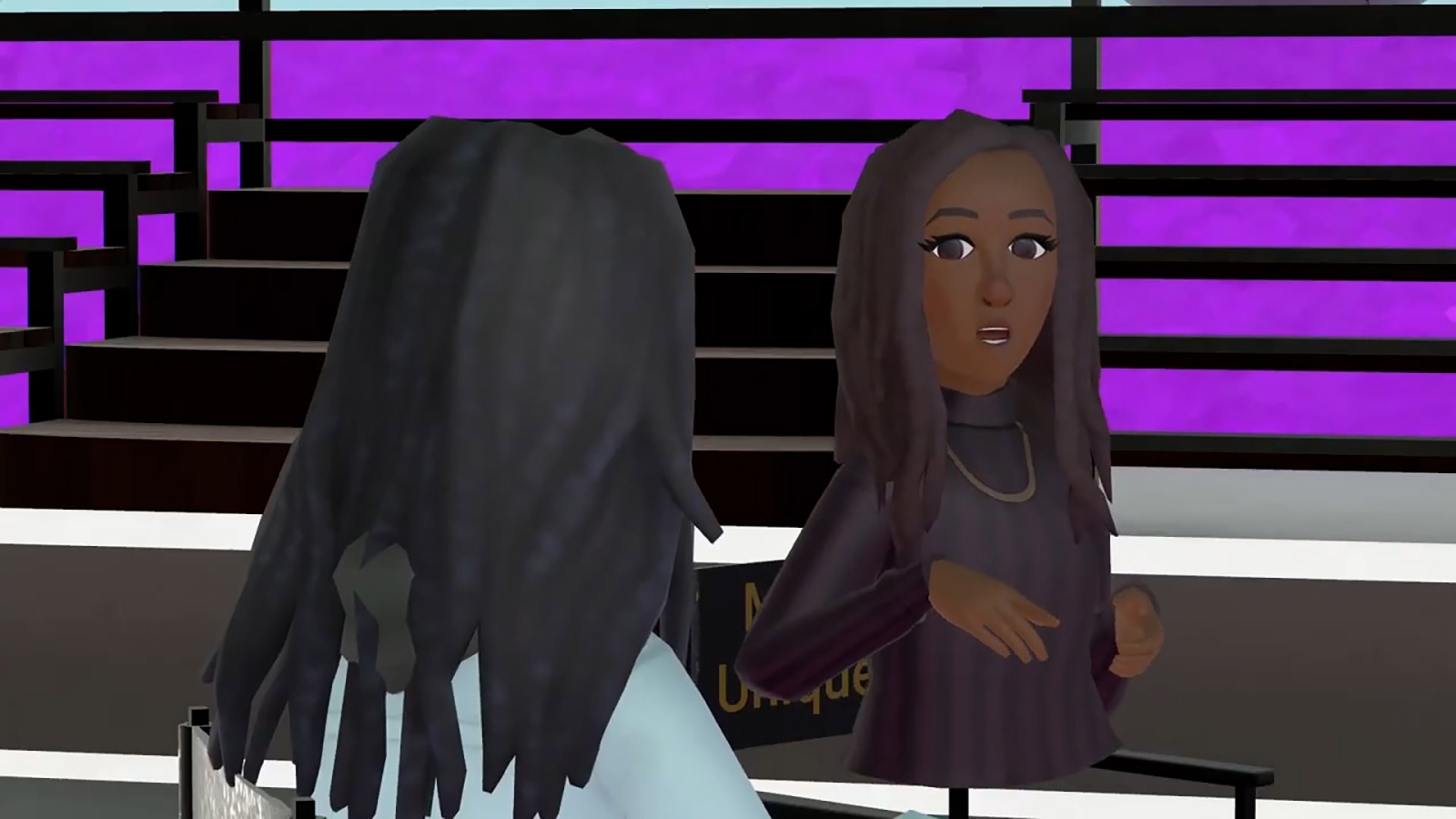 An over the shoulder view of Myla Unique Minor asking Renee questions