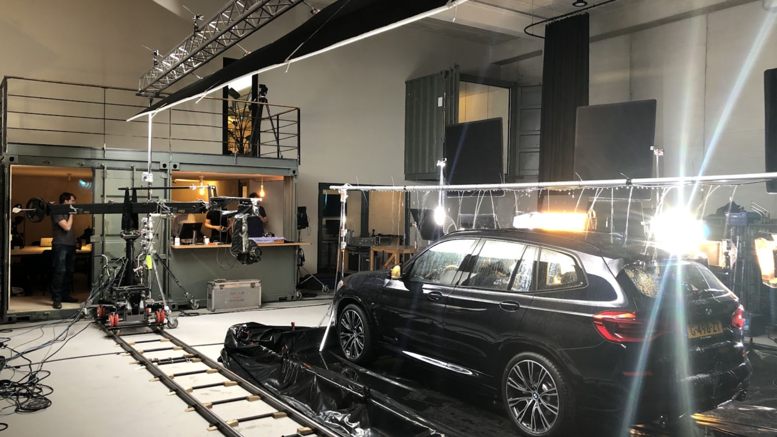A studio with film equipment shooting a suv commercial
