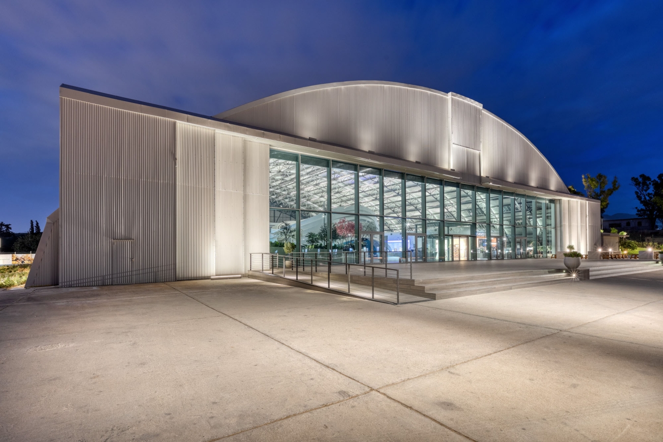 A large airplane hanger all lit up in the night