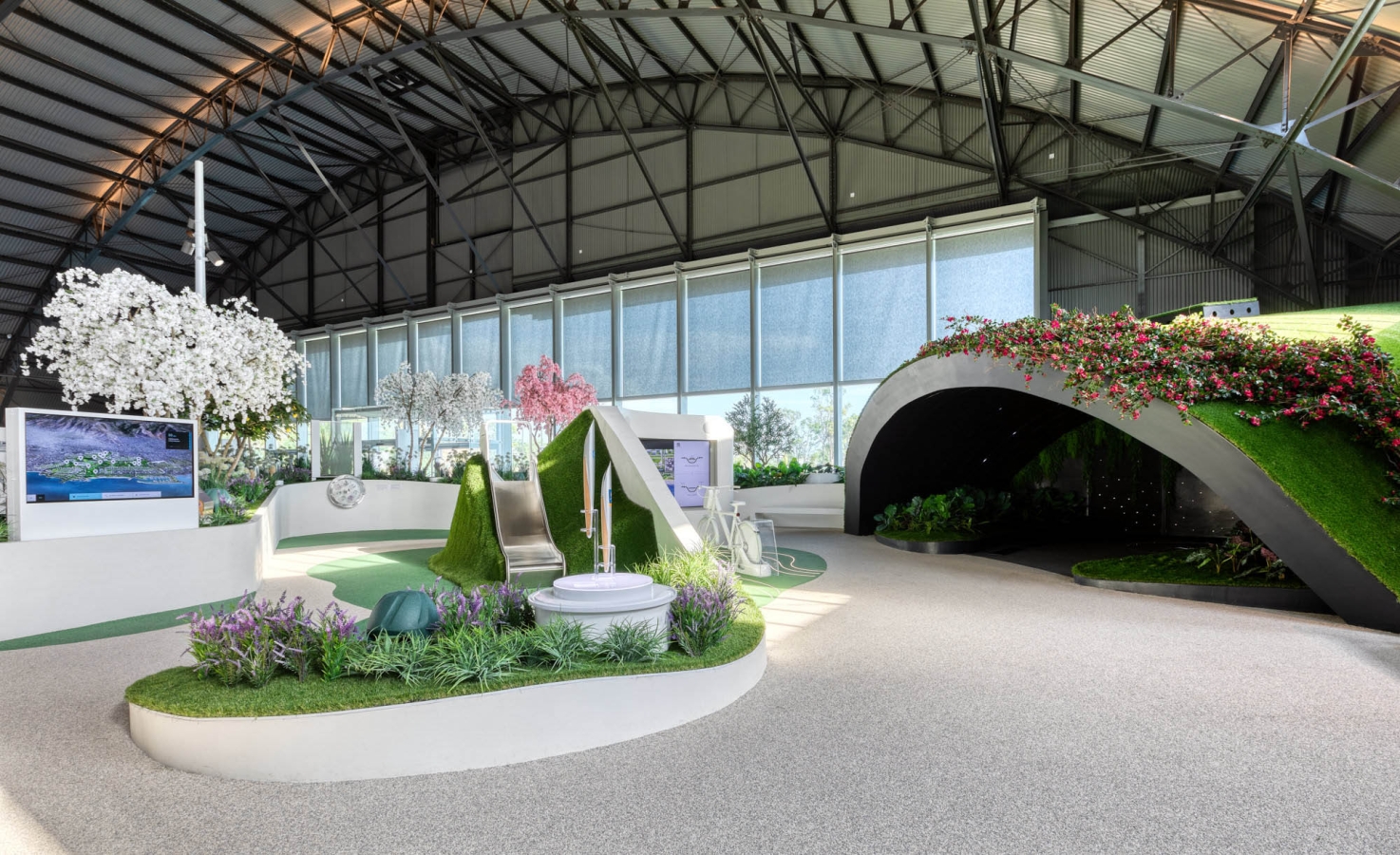 A garden like exhibit with colorful bushes and trees