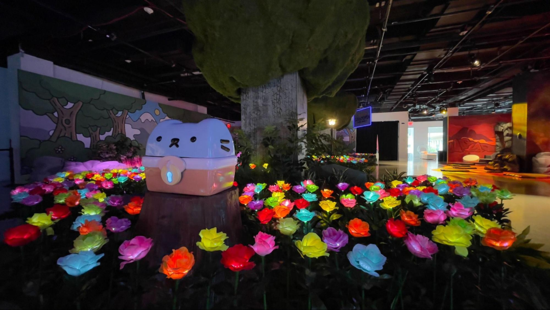 A glowing garden of flowers underneath a large tree