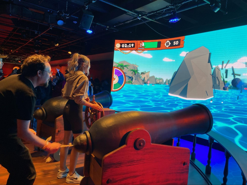 A person firing a canon at a screen 