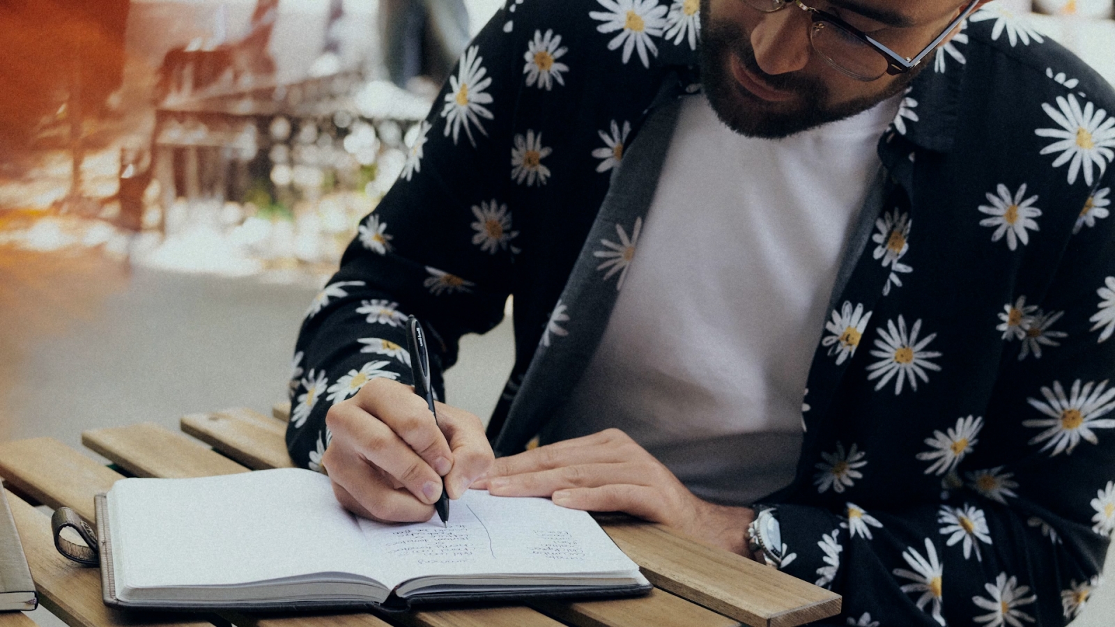 A person writing in a notebook