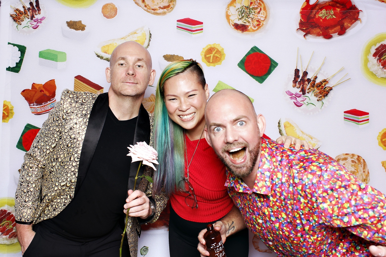 three employees partying in a photo booth