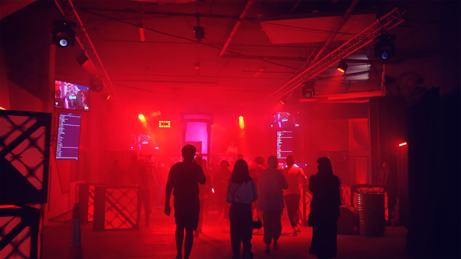A red lit Valorant obstacle course shows people running throughout