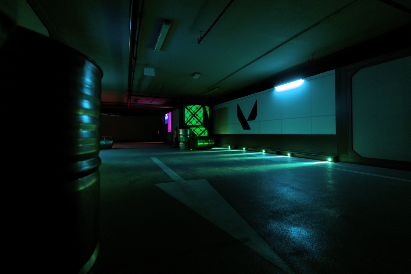 A dark hallway with a valorant logo lightly lit