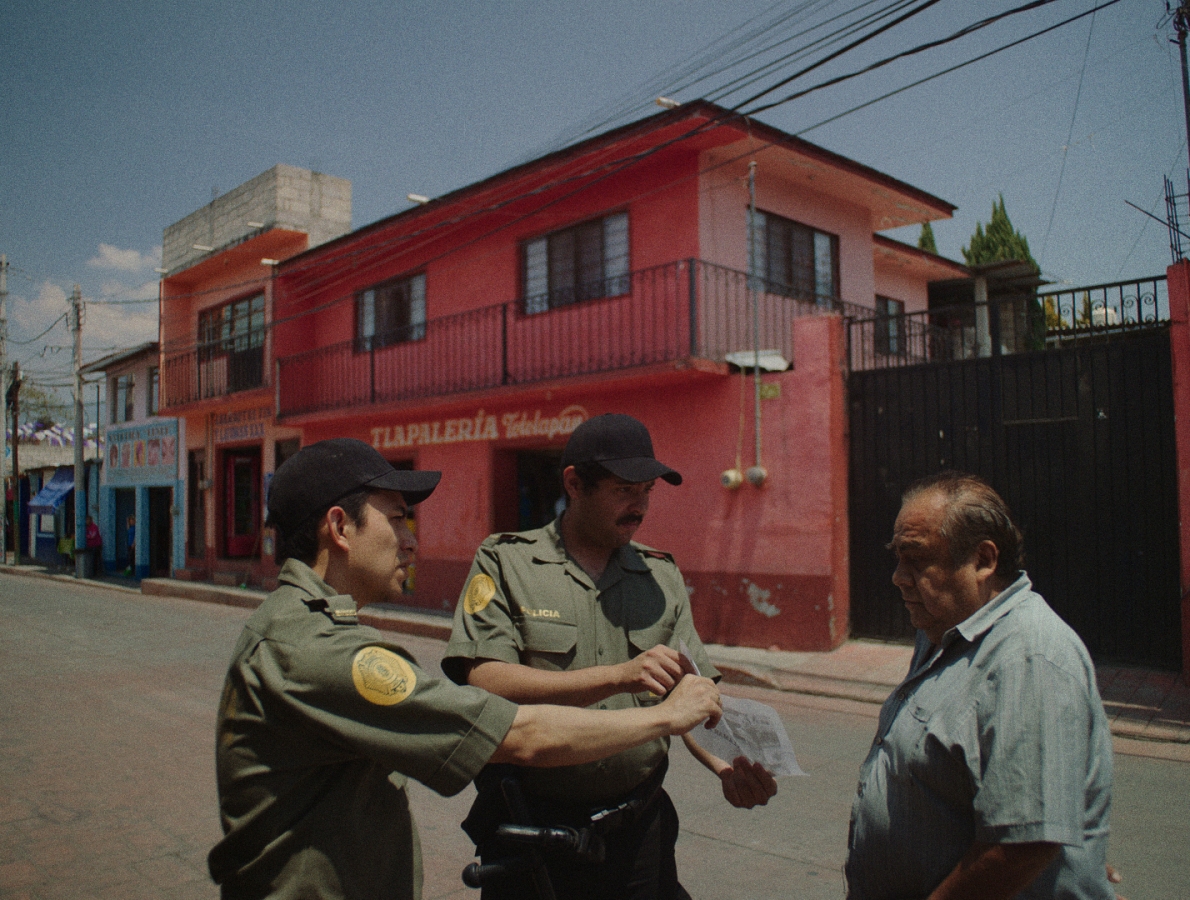 police asking somebody on the street in front of a red house about the missing girl.