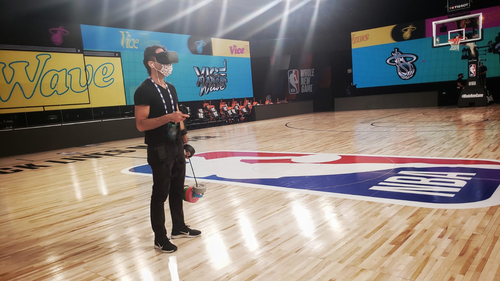 A person using a VR headset on a basketball floor