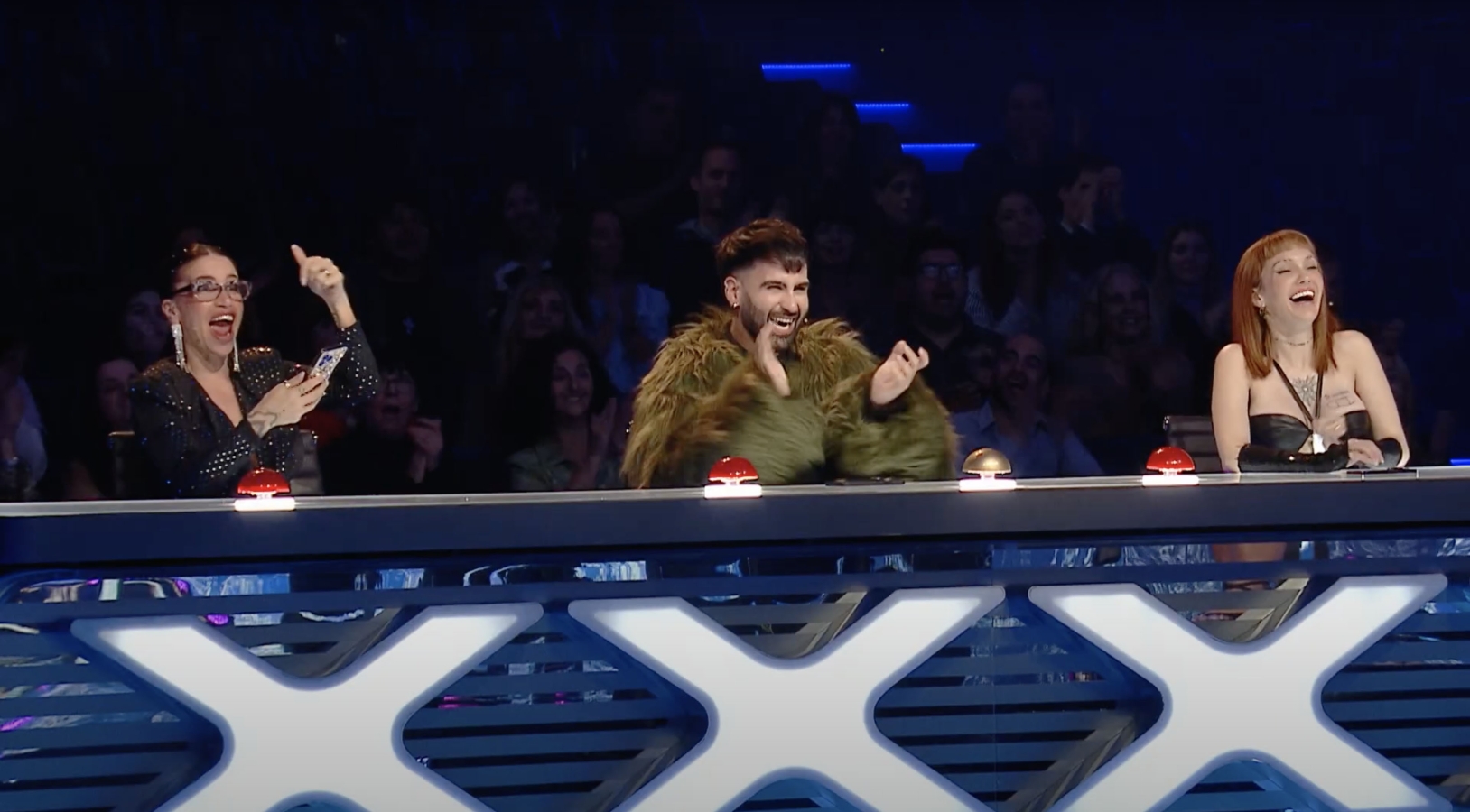 The talet show judges at their desk