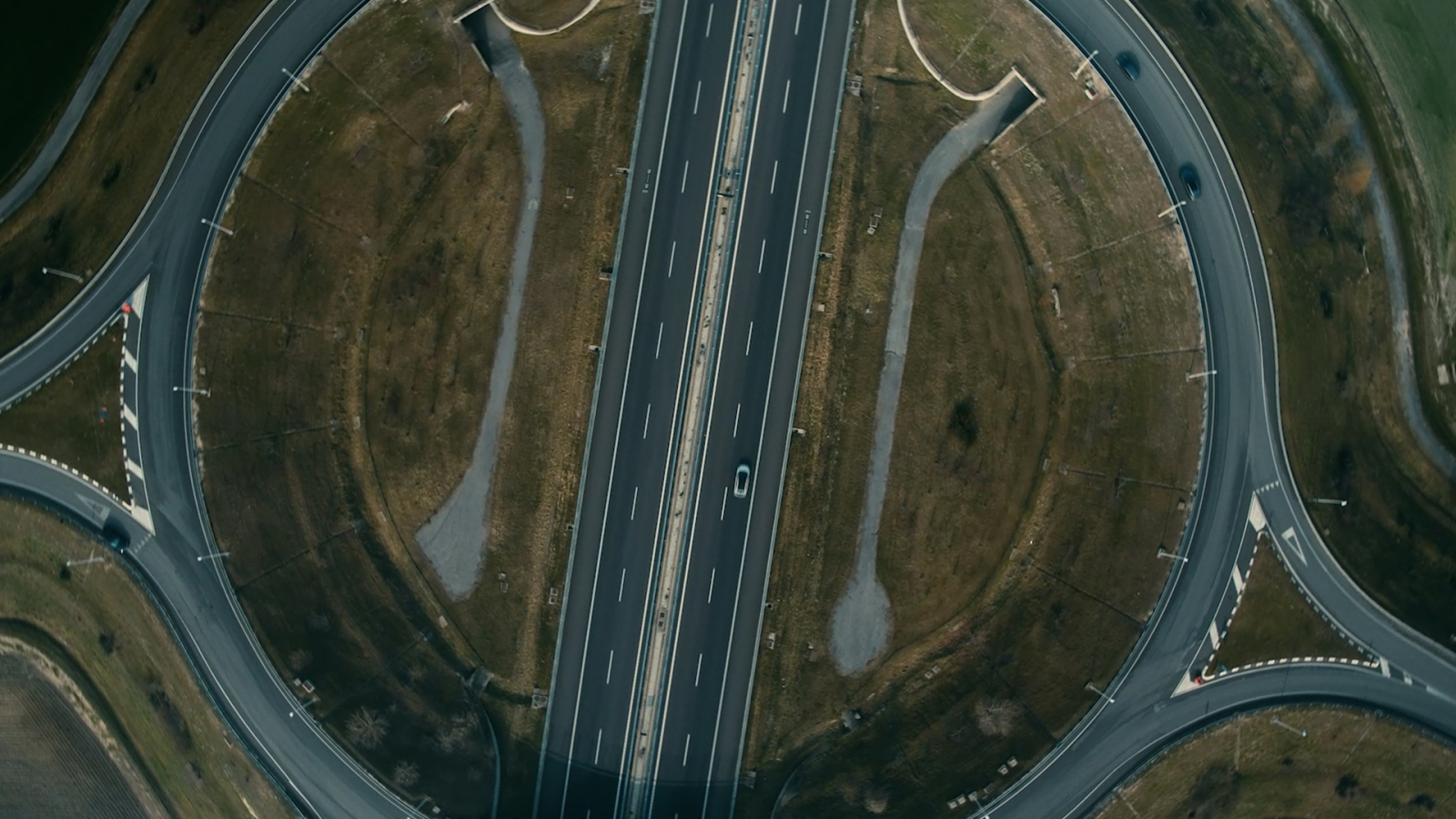 Air shot from above showcasing a highway with a circular shape.